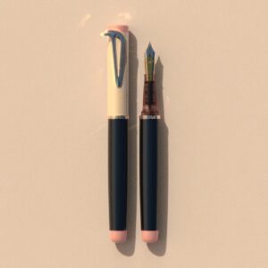 Beaklet Kyoto writing instrument, capped and uncapped, with an ivory cap, dark barrel and soft pink end details.